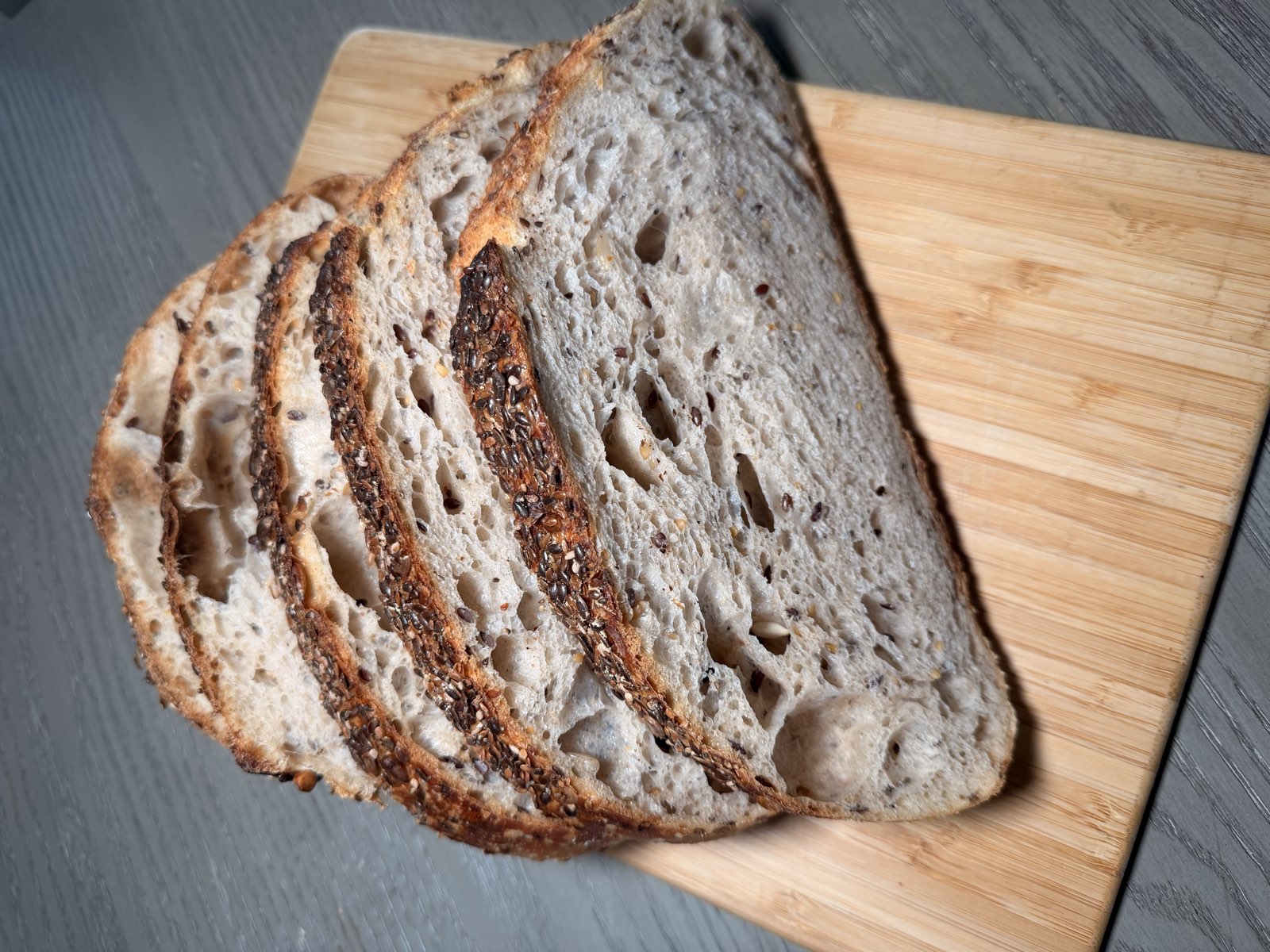 Freshly sliced artisan sourdough bread on a wooden board